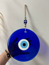 Close detail of the 22 cm blue glass evil eye wall charm with bold blue and white nazar rings