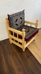 Maroon palace floor cushion set with ornate patterned cushion and chair arranged for relaxed majlis floor seating