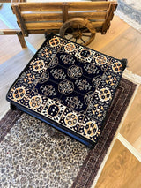 Navy Ottoman floor cushion in cotton, square 60 by 60 cm, sitting low on the floor as grounded decorative seating