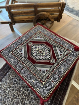 Maroon Palace Ottoman floor cushion in cotton, square 60 by 60 cm, placed low on the floor as warm decorative seating