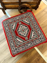 Red Palace Ottoman floor cushion in cotton, square 60 by 60 cm, placed low on the floor as warm decorative seating