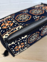 Navy armrest cushion arranged in a divan floor seating setup as a supportive elbow rest