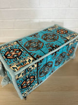 Aqua armrest cushion in 100% cotton resting beside floor cushions for majlis-style low seating