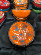 Shallow 5 cm handmade Turkish ceramic bowl in bright red, shown holding a small snack on the table