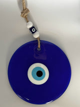 Evil eye wall hanging styled by a hallway doorway as a new home gift idea and house protection charm