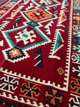 Close detail of the red pattern and flat cotton weave on the washable Turkish kilim rug