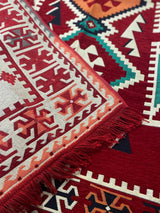 Red Turkish cotton kilim rug styled in a bright room as a standalone accent on timber flooring