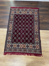 Burgundy Turkish cotton kilim rug laid flat showing its deep classic colour and flat woven cotton texture