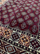 Close detail of the 100% cotton flat weave and burgundy tones on the washable Turkish kilim rug