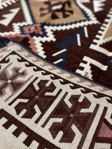 Brown Turkish cotton kilim rug styled in a relaxed living space beside timber furniture