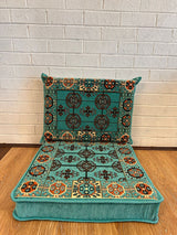 Aqua floor cushion set with a square seat cushion and matching back cushion arranged for low floor seating