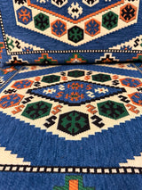 Close cotton-weave detail of the blue classic floor cushion showing firm sponge fill and stitched seam edge