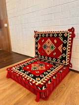 Two-piece red square floor cushion set laid out for geometric Turkish majlis floor seating