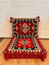 Red square floor cushion set with geometric squared cotton pattern across the red seat base and matching backrest