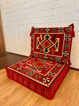 Two-piece red rhombus floor cushion set arranged on the floor for patterned Turkish majlis seating