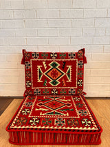 Red rhombus floor cushion set with diamond-lattice cotton pattern across the red square seat base and backrest