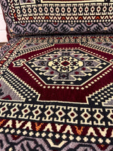 Close view of dark red palace floor cushion showing detailed palace pattern and firm sponge filled cotton cover