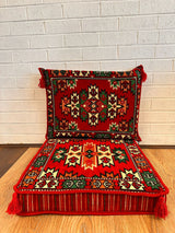 Red oriental floor cushion set with decorative oriental motif on warm red cotton seat base and backrest
