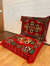 Two-piece red oriental floor cushion set laid out for decorative Turkish majlis floor seating