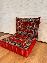 Two-piece red floor cushion set laid on floor with seat and back cushion for warm Turkish majlis seating