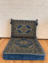 Blue floor cushion set with a square seat cushion and matching back cushion arranged for low floor seating