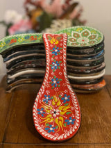 Handpainted red ceramic spoon holder displayed at full 25 cm length on a wooden kitchen surface