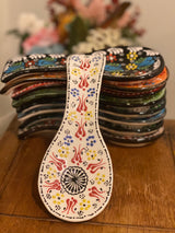 Handpainted white ceramic spoon holder shown at full 25 cm length on a bright kitchen bench