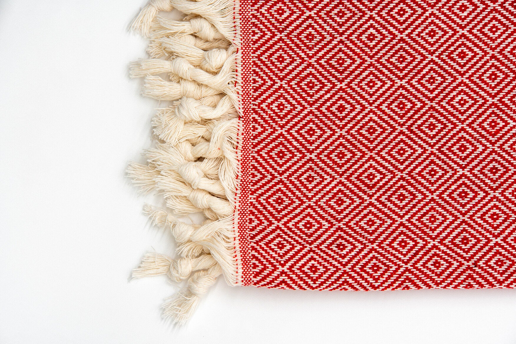 Handwoven Turkish cotton peshtemal folded with hammam accessories, setting the traditional Turkish bath ritual mood